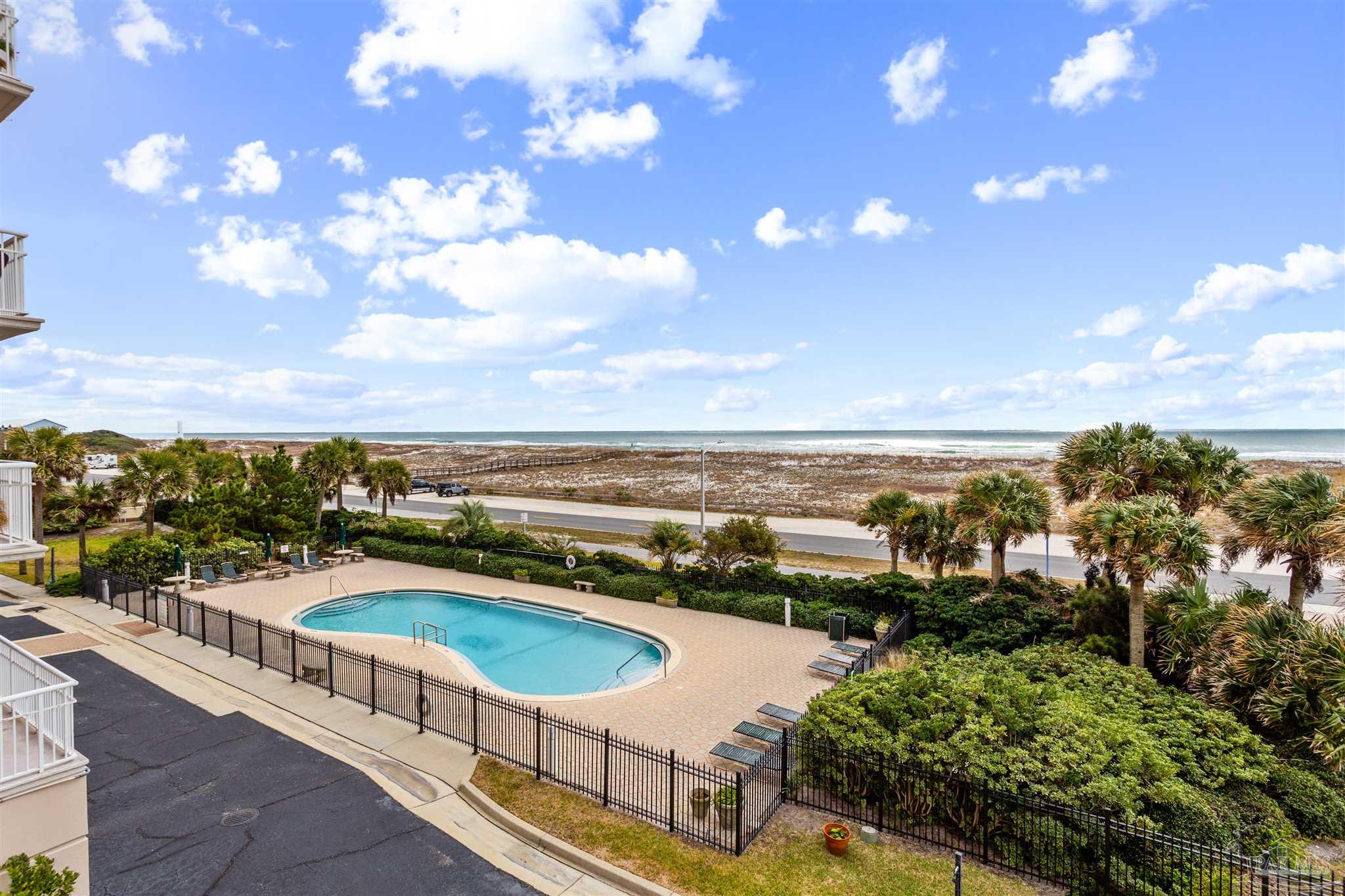 800 Fort Pickens Road, Unit 204 Pensacola Beach, FL 32561 - Photo 13 of 45 a view of a swimming pool with an ocean view