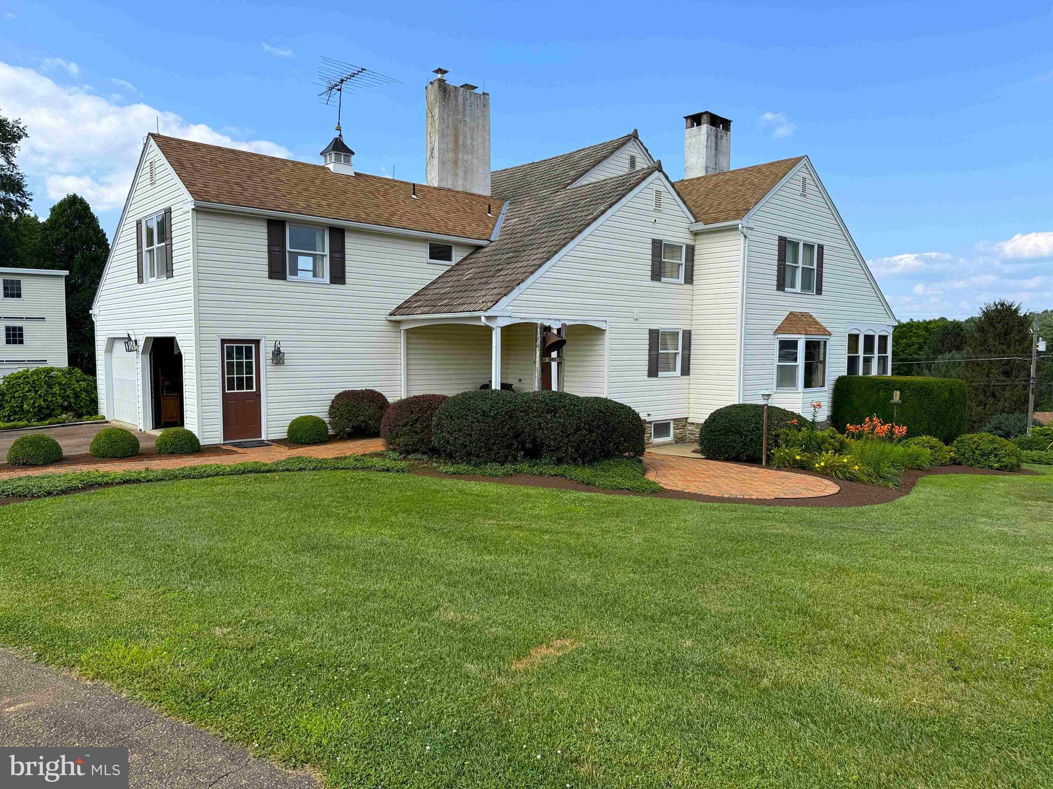 a front view of house with yard and green space