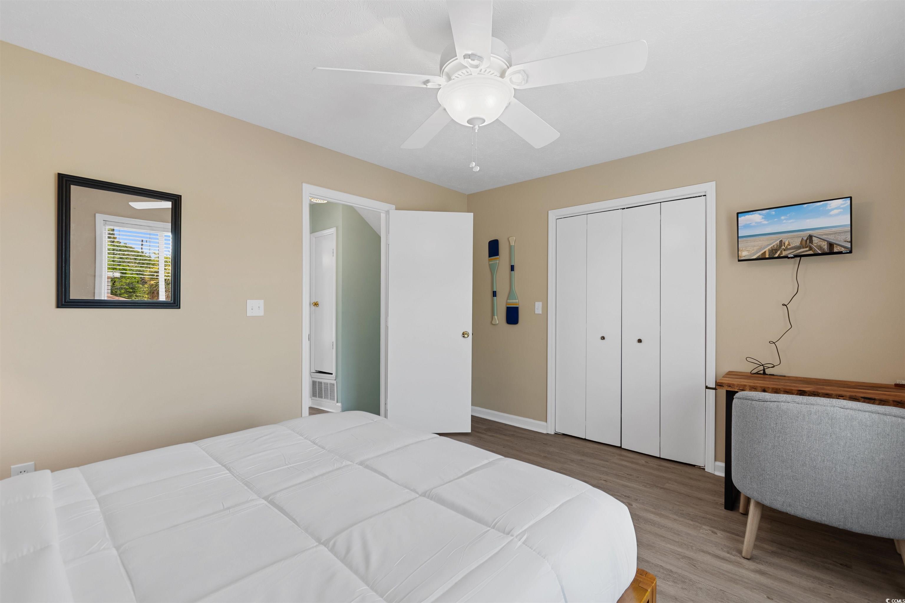 605 A 17th Avenue South North Myrtle Beach, SC 29582 - Photo 17 of 36 Bedroom featuring wood finished floors, a ceiling fan, and a closet