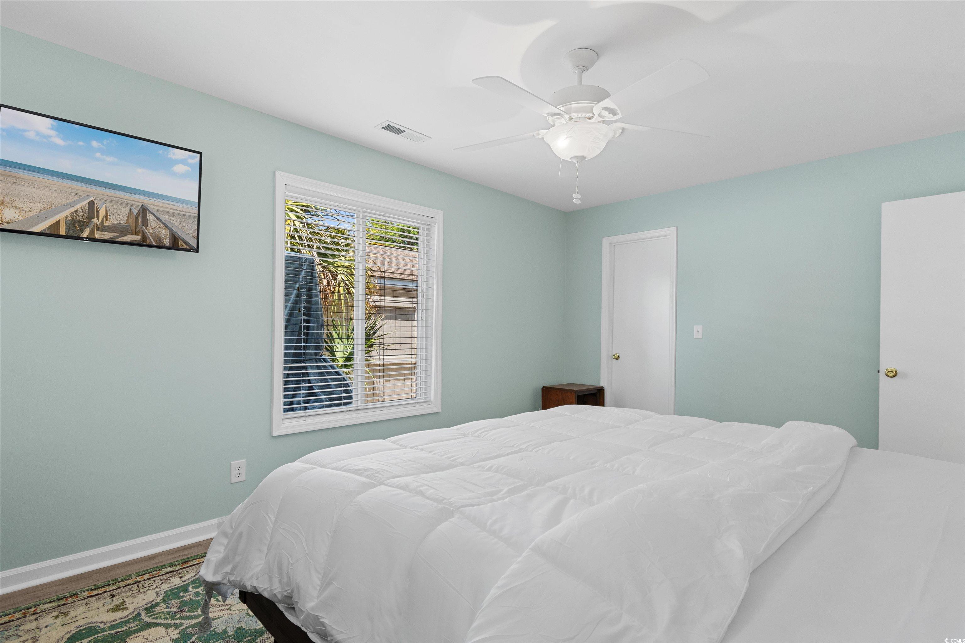 605 A 17th Avenue South North Myrtle Beach, SC 29582 - Photo 22 of 36 Bedroom featuring a ceiling fan and wood finished floors