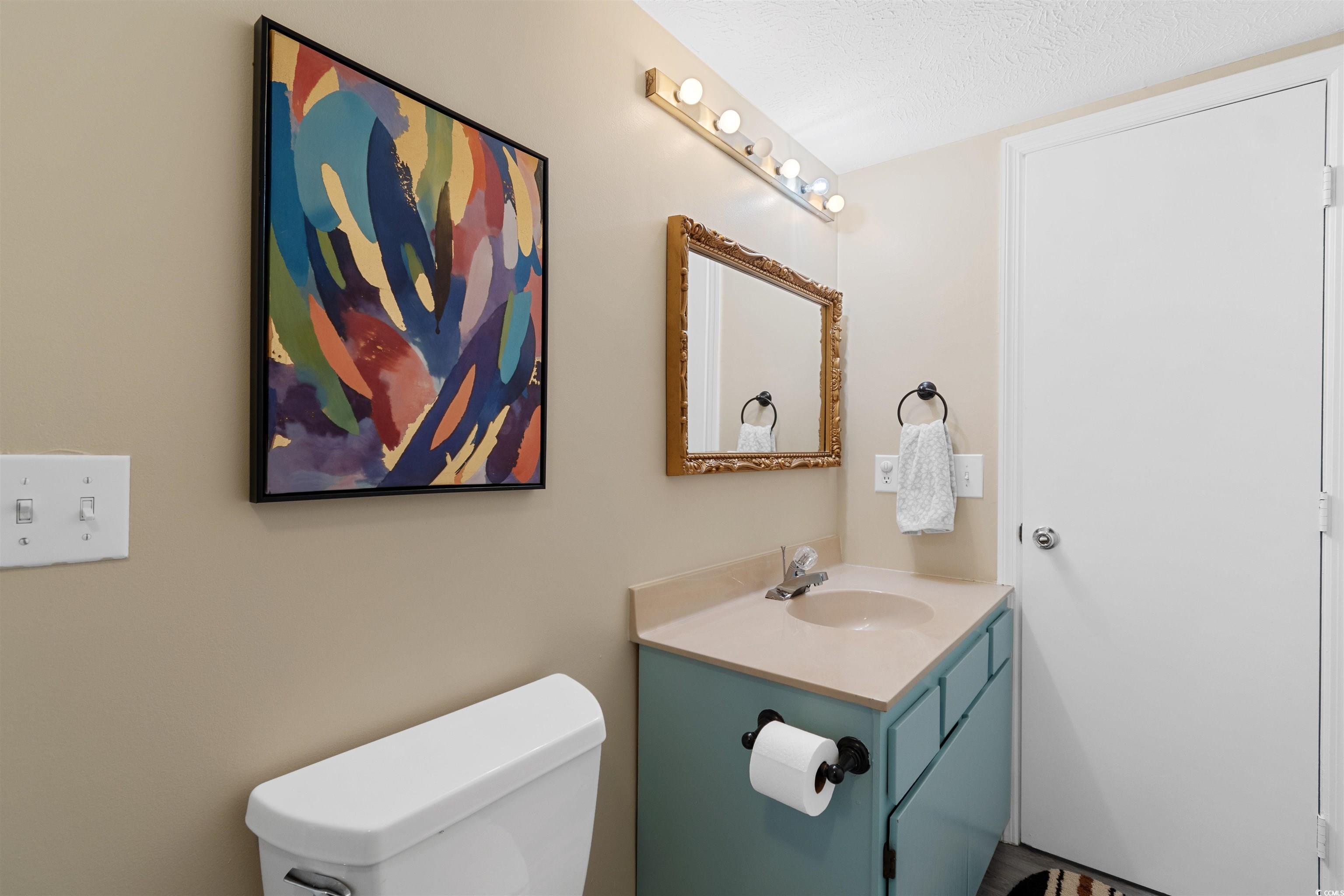 605 A 17th Avenue South North Myrtle Beach, SC 29582 - Photo 24 of 36 Half bathroom featuring vanity and a textured ceiling