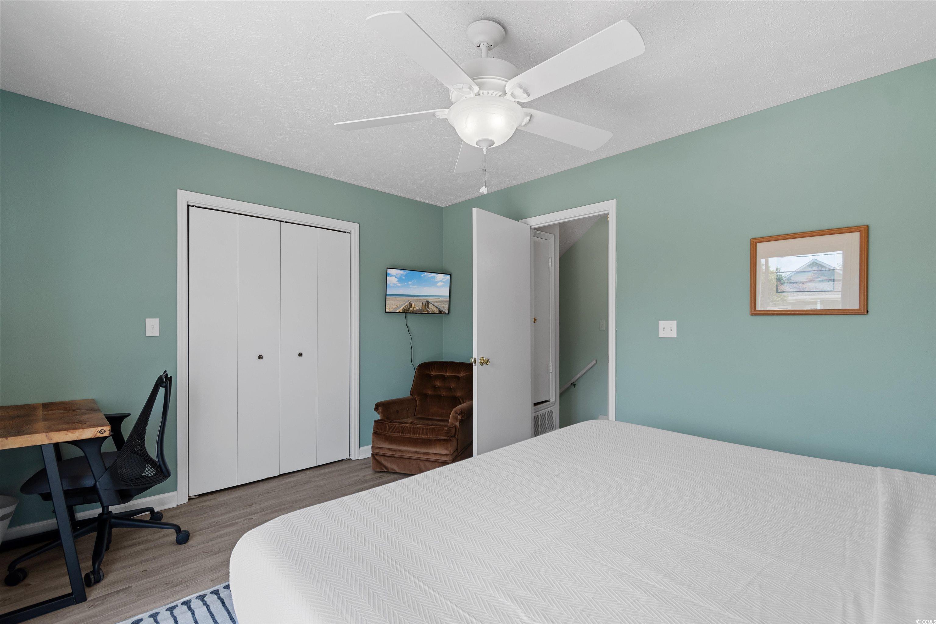 605 A 17th Avenue South North Myrtle Beach, SC 29582 - Photo 26 of 36 Bedroom featuring wood finished floors, a closet, a ceiling fan, and an office area