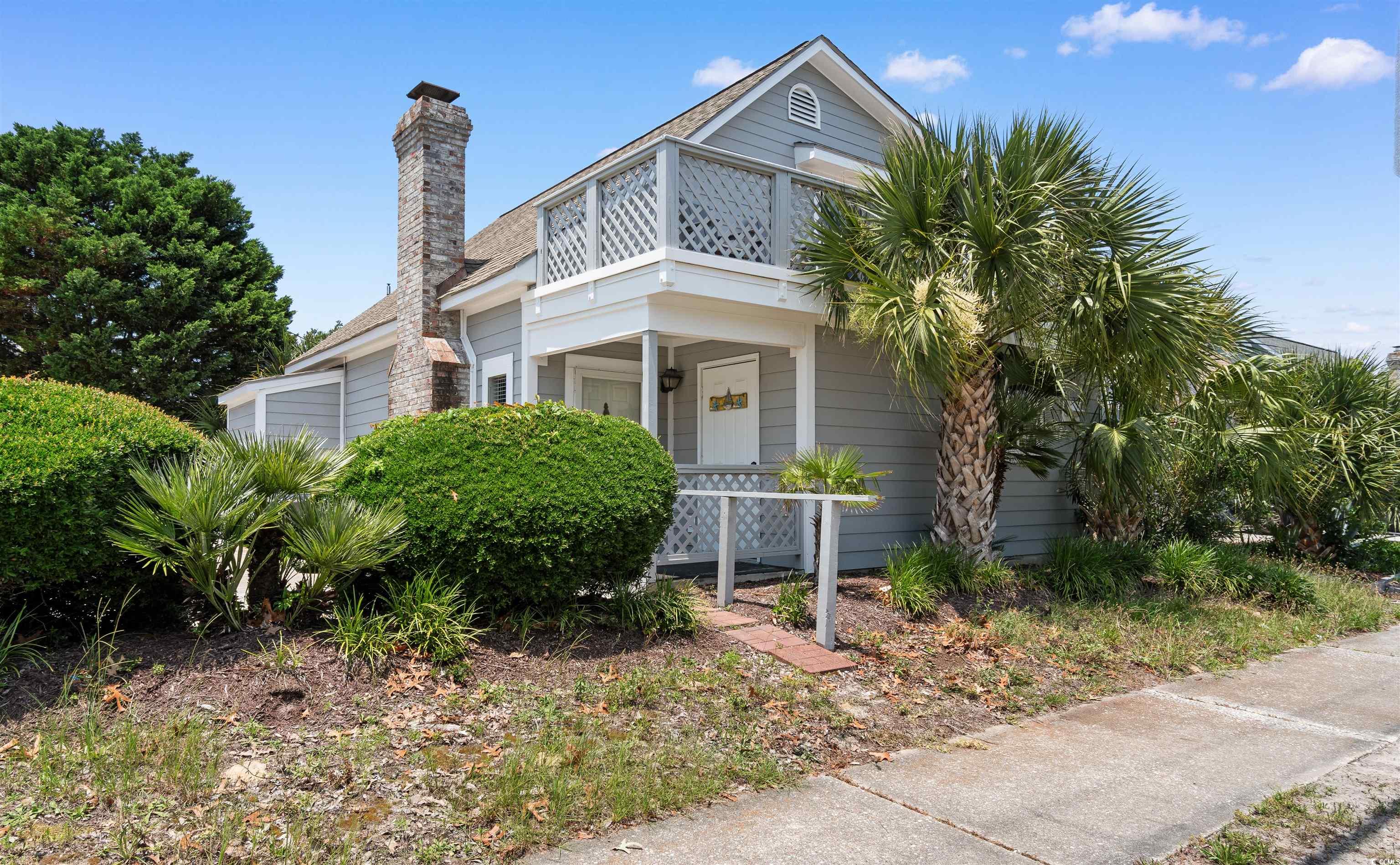 605 A 17th Avenue South North Myrtle Beach, SC 29582 - Photo 32 of 36 View of front facade with a chimney and covered porch