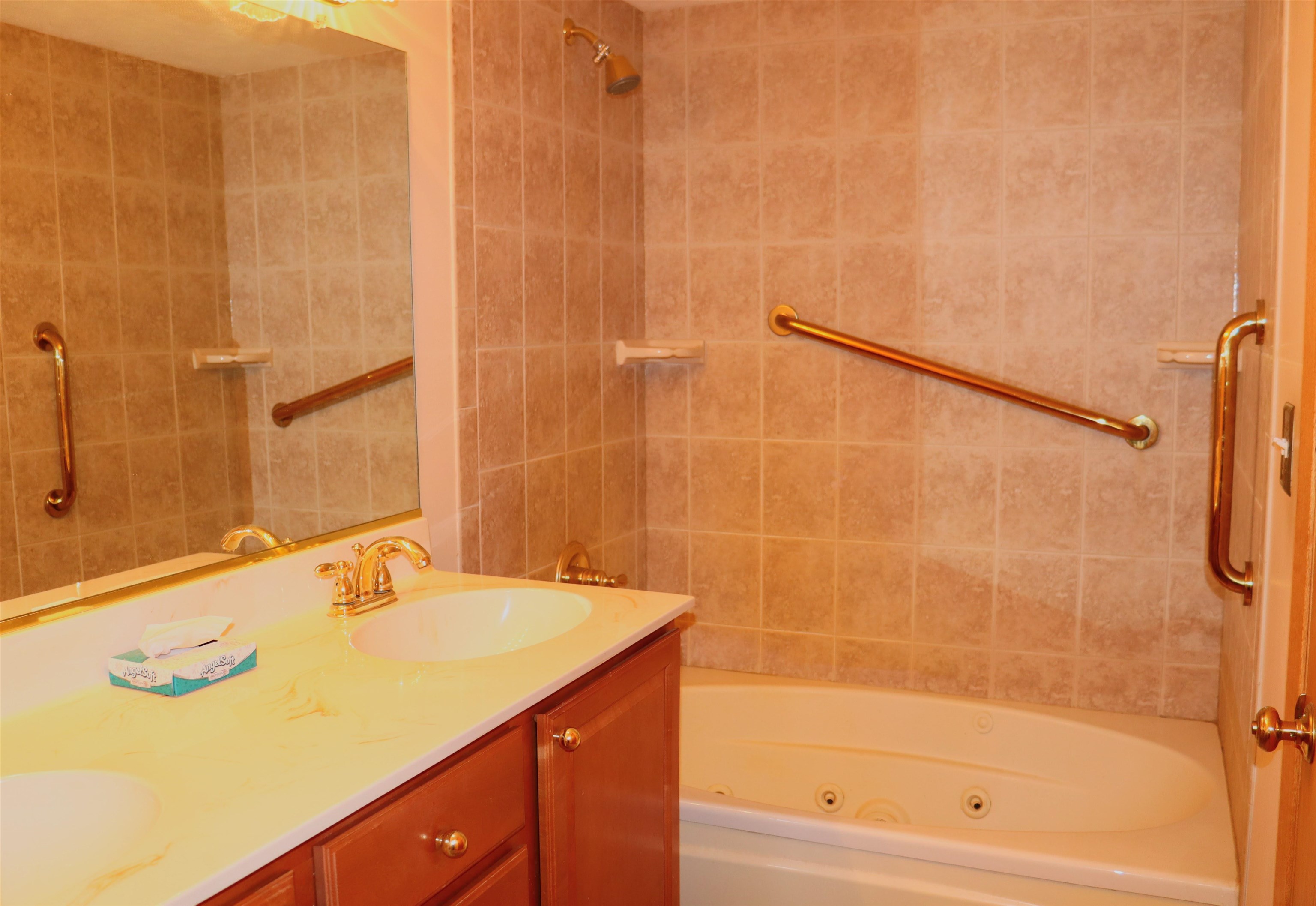 470 Brookside Road North Barrington, IL 60010 - Photo 11 of 38 a bathroom with a granite countertop sink a mirror and a shower