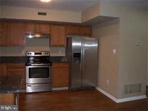 a kitchen with kitchen island a counter space a sink and stainless steel appliances