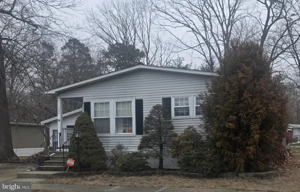a house that has a tree in front of it