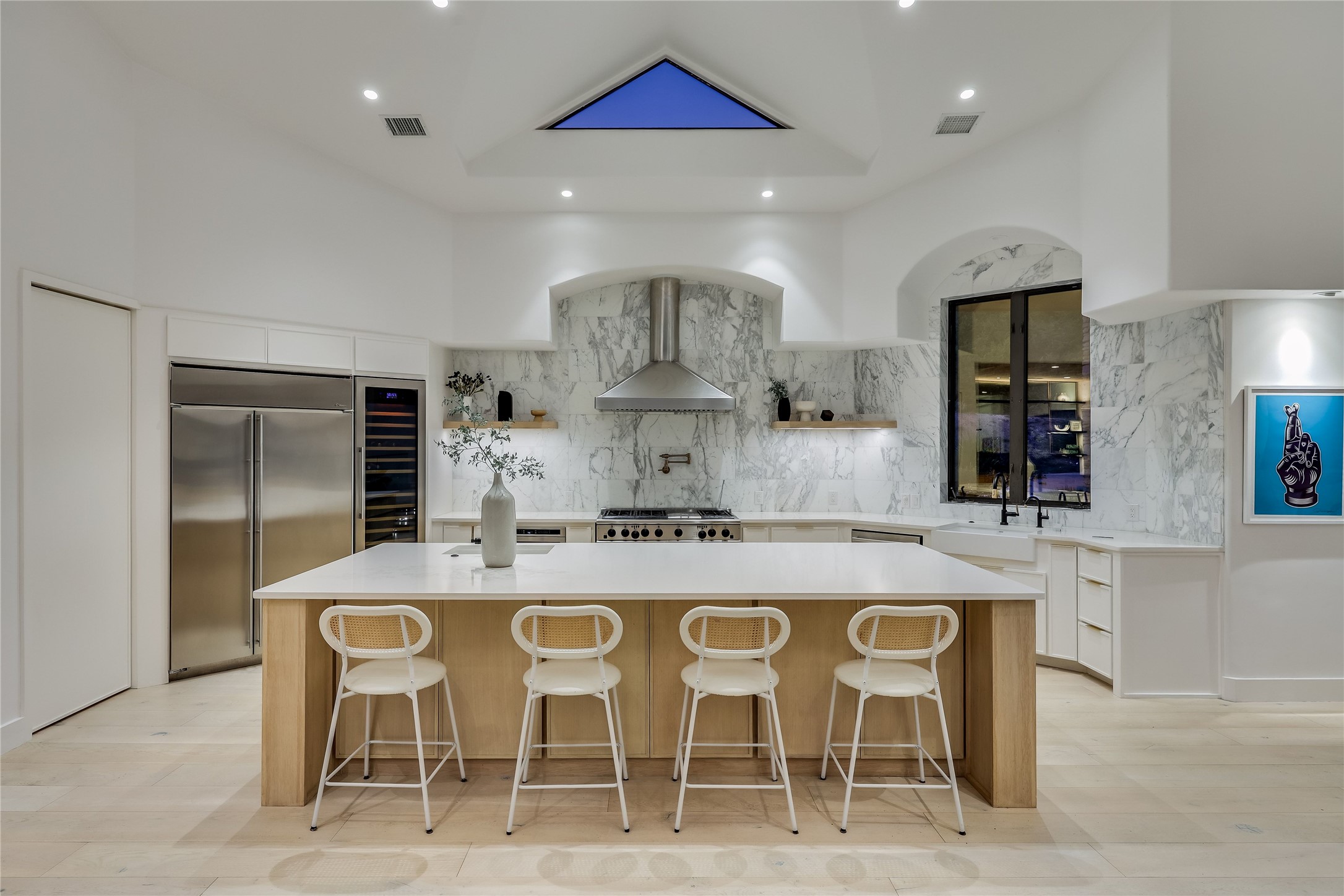1016 Wild Basin Ledge Austin, TX 78746 - Photo 5 of 38 Oversized white oak island, gold calcutta backsplash, GE Monogram stainless steel appliances, wine fridge