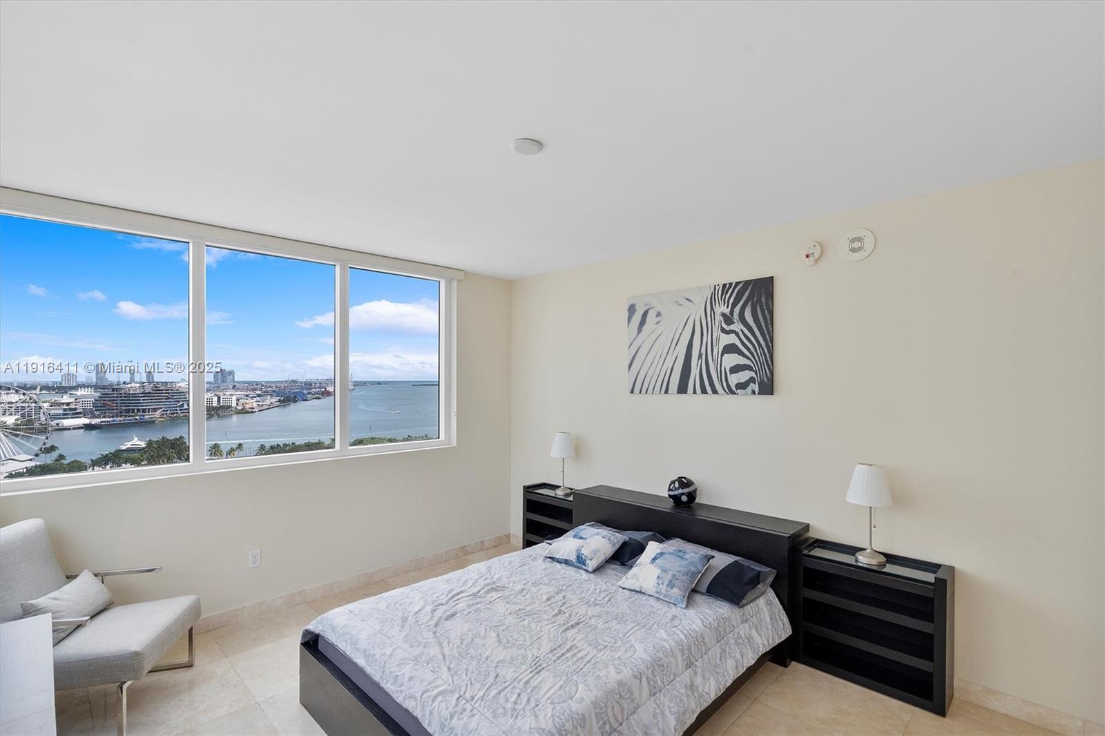 253 Northeast 2nd Street, Unit 1803 Miami, FL 33132 - Photo 14 of 23 a bedroom with a bed and a window
