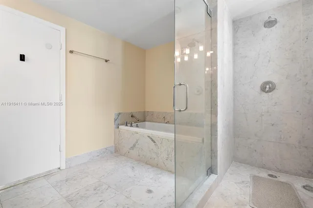 a bathroom with a bathtub and shower