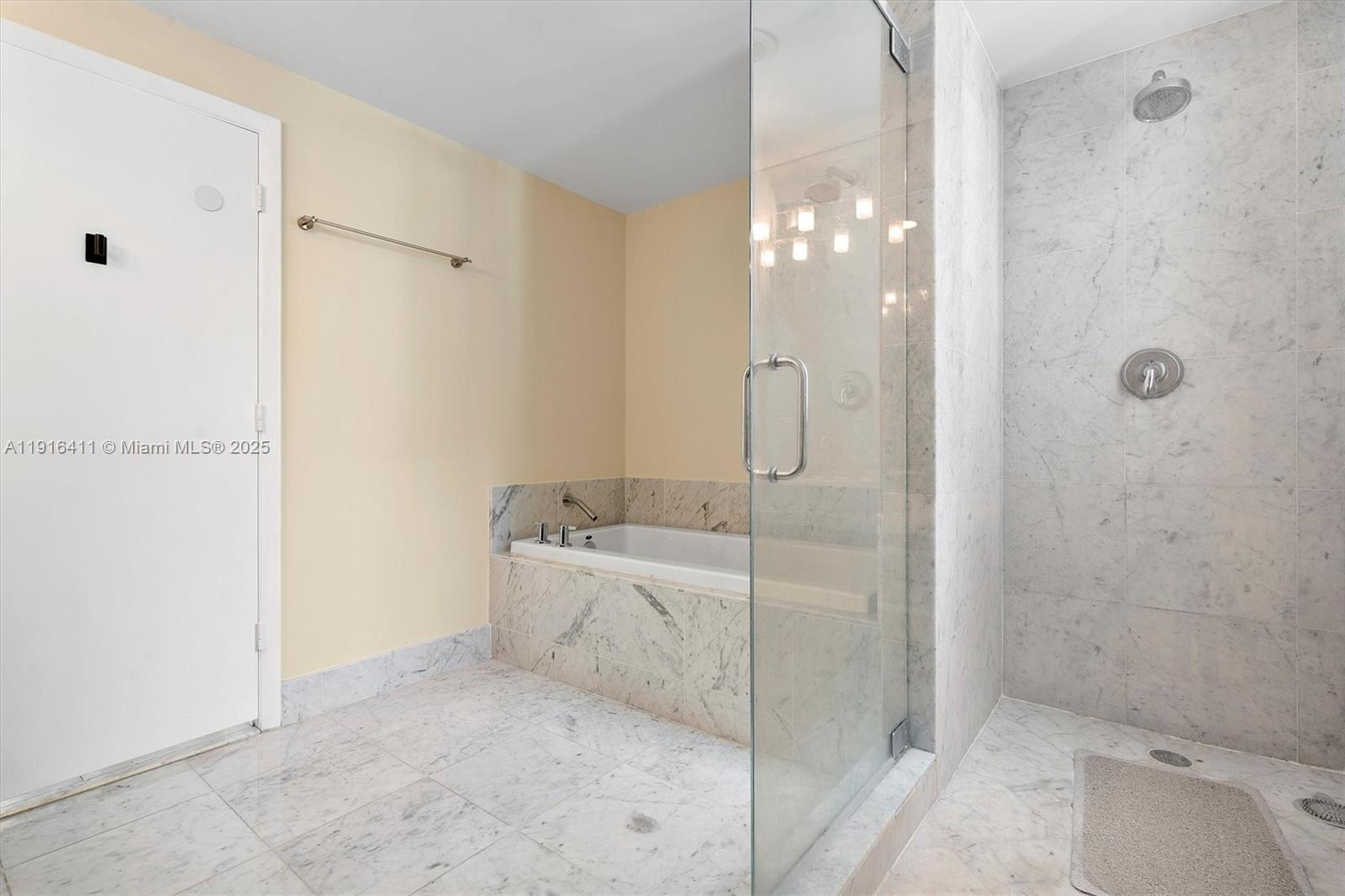 253 Northeast 2nd Street, Unit 1803 Miami, FL 33132 - Photo 18 of 23 a bathroom with a bathtub and shower