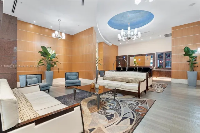 a living room with furniture and a chandelier