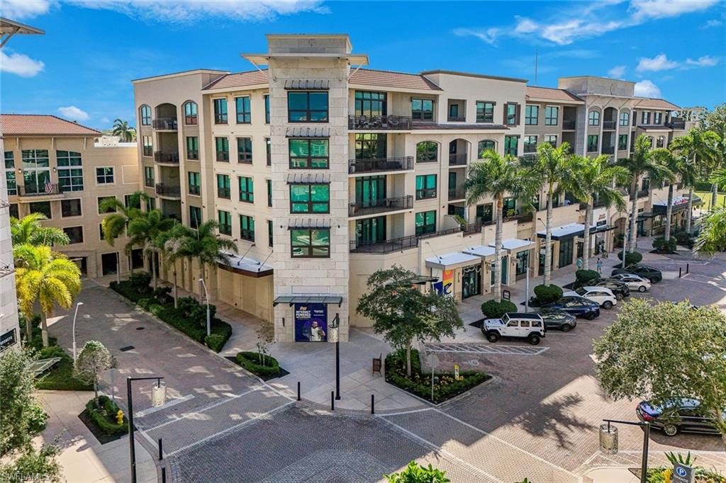 9123 Strada Place, Unit 7201 Naples, FL 34108 - Photo 45 of 50 a front view of a building with garden