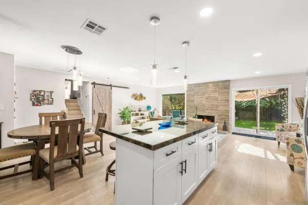 a open kitchen with stainless steel appliances kitchen island granite countertop a sink and cabinets