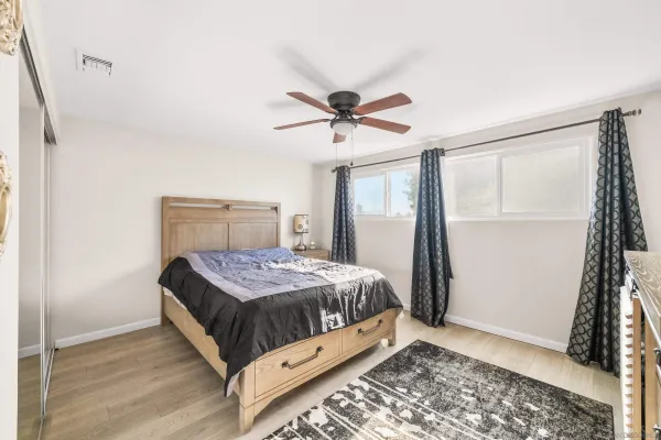 a bedroom with a bed and a window