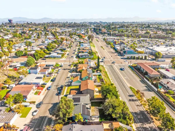 an aerial view of residential houses with city view