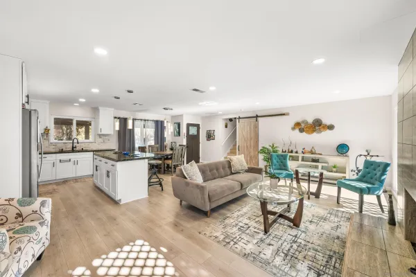 a living room with furniture and view of kitchen