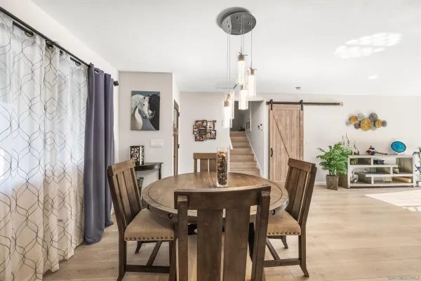 a view of a dining room with furniture and chandelier