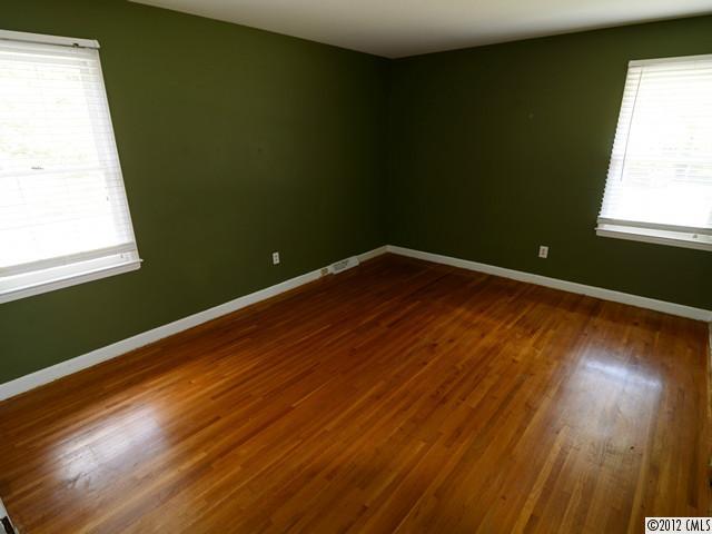 1314 Erinshire Road Charlotte, NC 28211 - Photo 11 of 16 a view of an empty room with wooden floor and a window