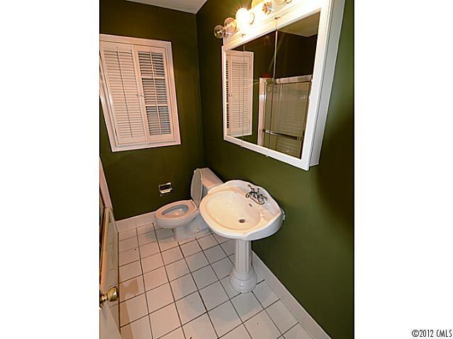1314 Erinshire Road Charlotte, NC 28211 - Photo 12 of 16 a bathroom with a toilet a sink and mirror