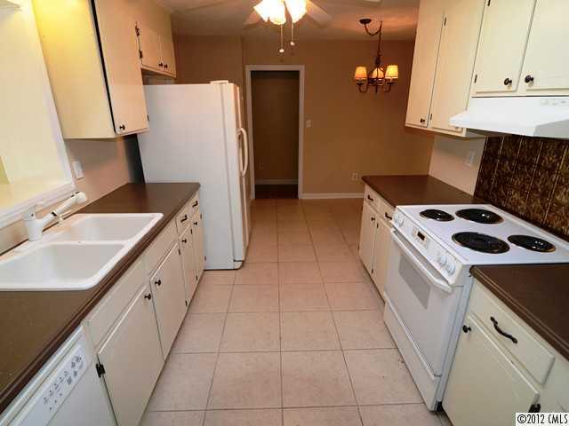 1314 Erinshire Road Charlotte, NC 28211 - Photo 3 of 16 a kitchen with a sink a stove and a refrigerator