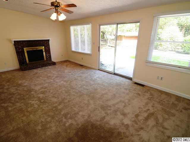 1314 Erinshire Road Charlotte, NC 28211 - Photo 5 of 16 an empty room with windows and fireplace