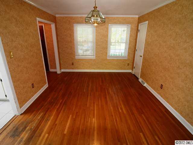 1314 Erinshire Road Charlotte, NC 28211 - Photo 6 of 16 a view of an empty room with wooden floor and a window