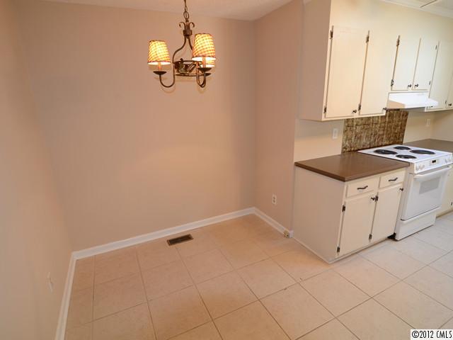 1314 Erinshire Road Charlotte, NC 28211 - Photo 7 of 16 a kitchen with white cabinets and white appliances