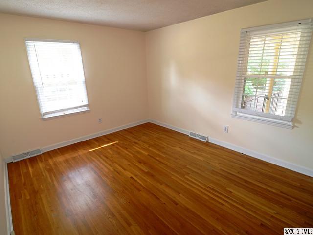 1314 Erinshire Road Charlotte, NC 28211 - Photo 10 of 16 a view of an empty room with wooden floor and a window
