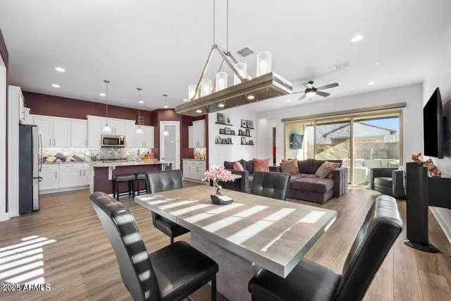 a living room with lots of furniture and kitchen view