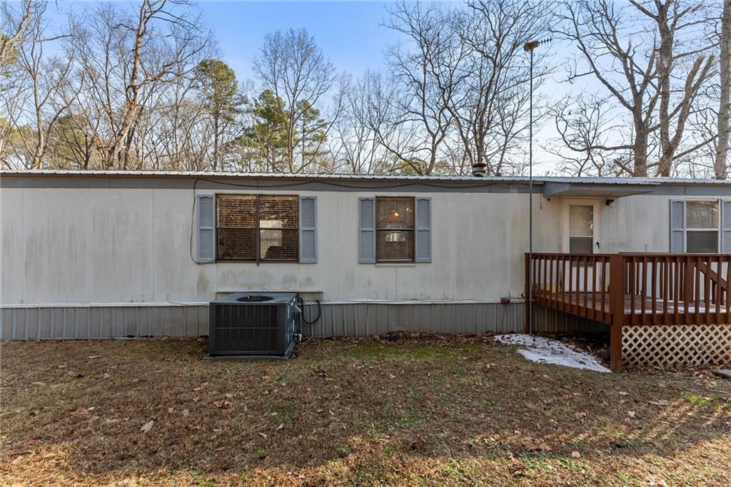 347 Norma Road Dawsonville, GA 30534 - Photo 25 of 33 a backyard of a house with a garden and barbeque oven