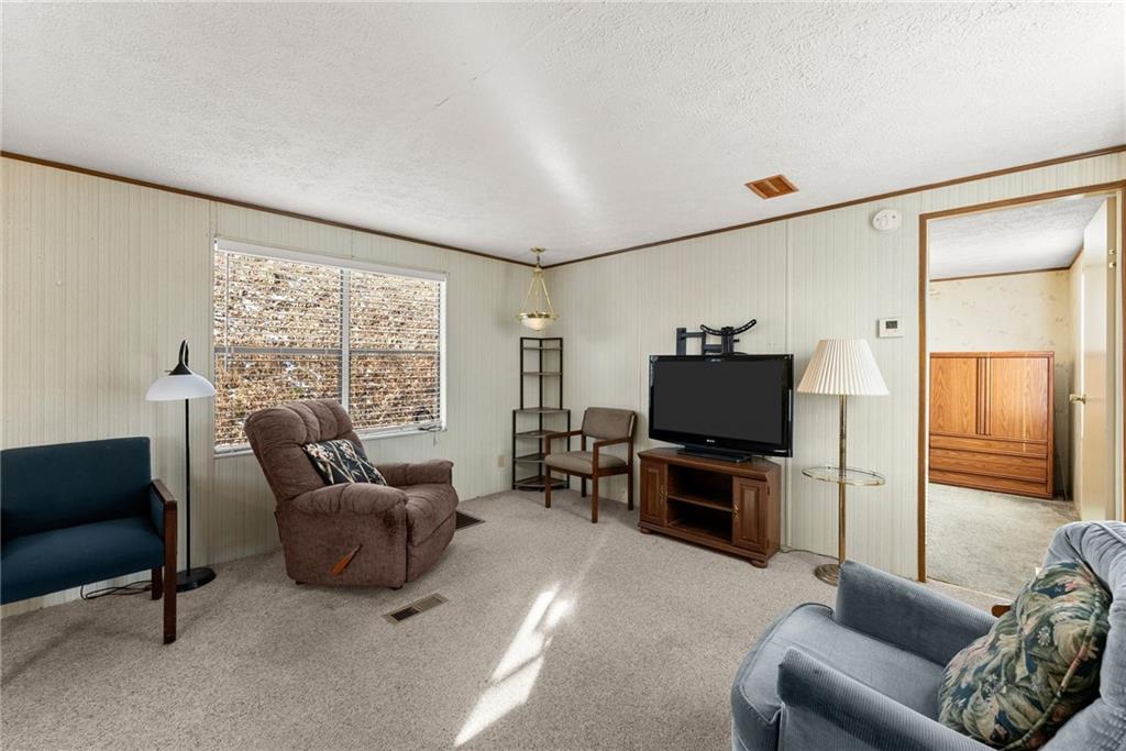 347 Norma Road Dawsonville, GA 30534 - Photo 5 of 33 a living room with furniture and a flat screen tv