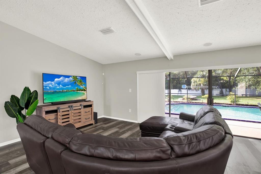 7487 River Country Drive Weeki Wachee, FL 34607 - Photo 22 of 53 a living room with furniture and a flat screen tv