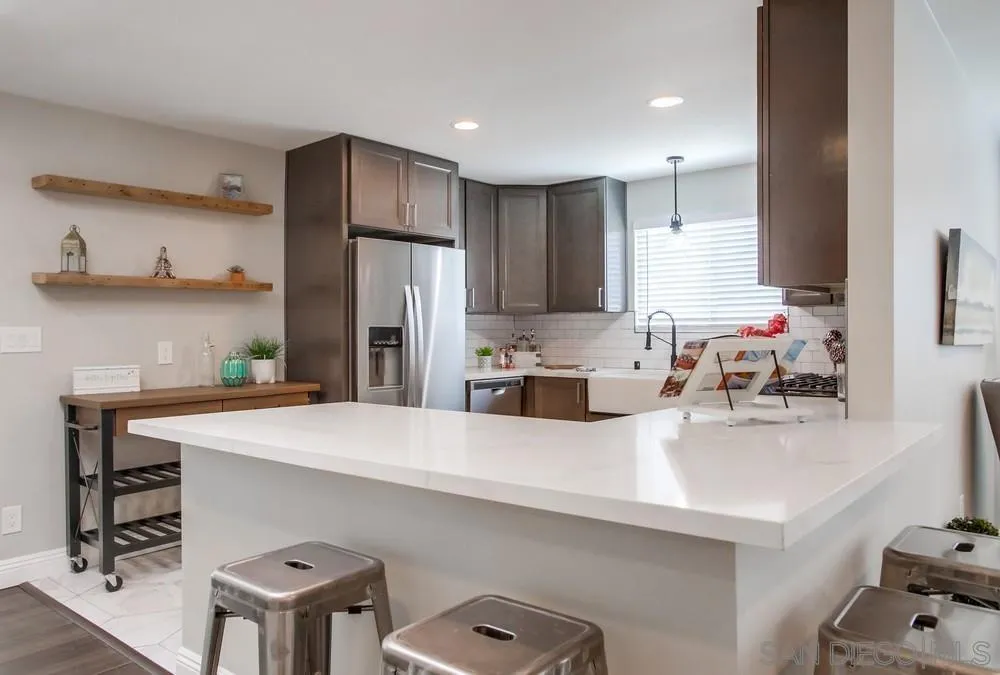 8348 Rumson Drive Santee, CA 92071 - Photo 16 of 53 a kitchen with kitchen island a stove a sink and a refrigerator