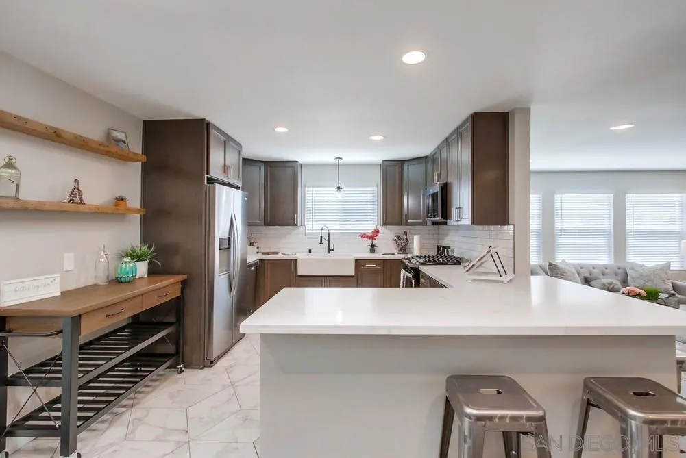 8348 Rumson Drive Santee, CA 92071 - Photo 17 of 53 a kitchen with a sink a refrigerator and chairs