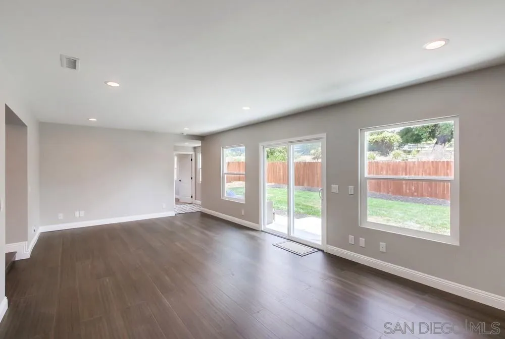 8348 Rumson Drive Santee, CA 92071 - Photo 22 of 53 an empty room with wooden floor and windows