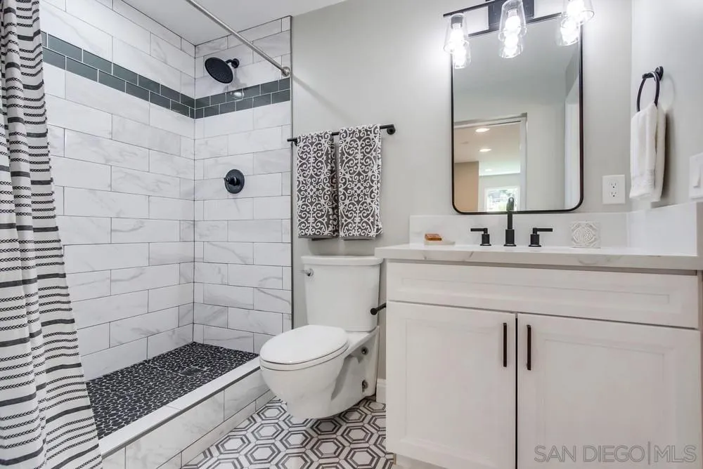8348 Rumson Drive Santee, CA 92071 - Photo 30 of 53 a bathroom with a sink toilet a mirror and shower
