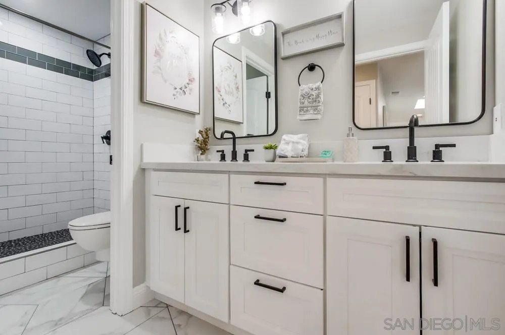 8348 Rumson Drive Santee, CA 92071 - Photo 37 of 53 a bathroom with a double vanity sink toilet and mirror