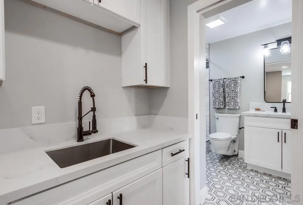 8348 Rumson Drive Santee, CA 92071 - Photo 40 of 53 a bathroom with a sink a toilet and a mirror