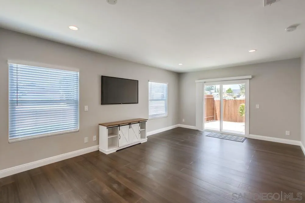 8348 Rumson Drive Santee, CA 92071 - Photo 7 of 53 an empty room with wooden floor and windows