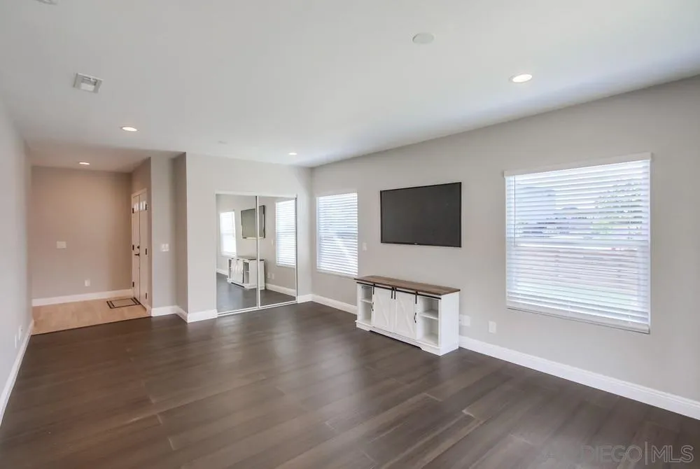 8348 Rumson Drive Santee, CA 92071 - Photo 9 of 53 a view of an empty room with wooden floor and a window