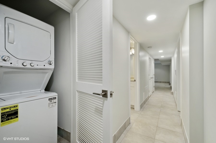 5816 North Ridge Avenue, Unit 1F Chicago, IL 60660 - Photo 16 of 18 a bathroom with a granite countertop sink a toilet and a mirror