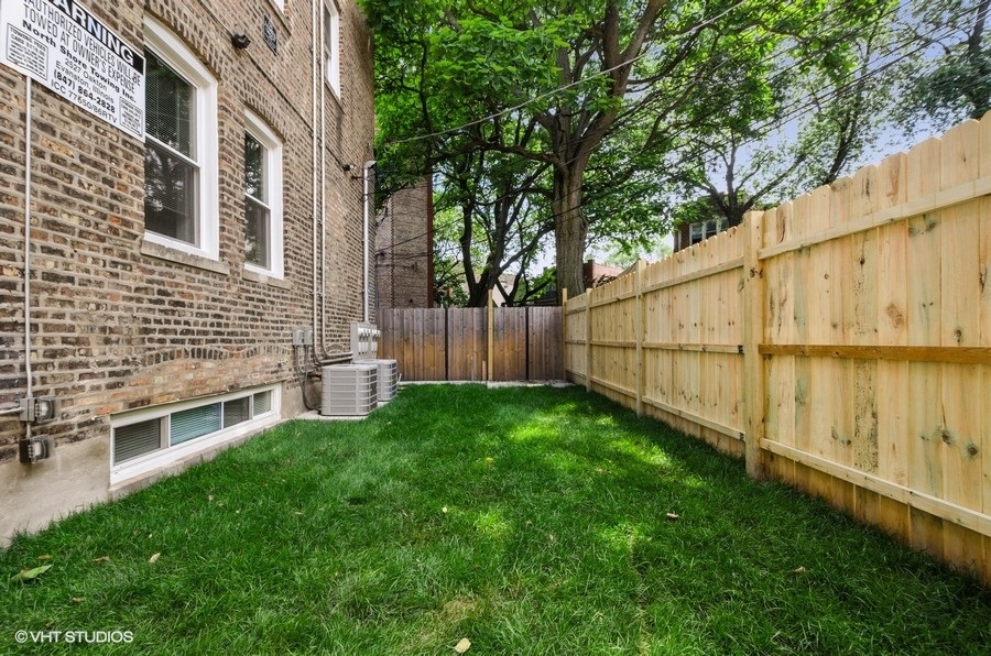 5816 North Ridge Avenue, Unit 1F Chicago, IL 60660 - Photo 17 of 18 a view of backyard with barbeque grill and wooden fence