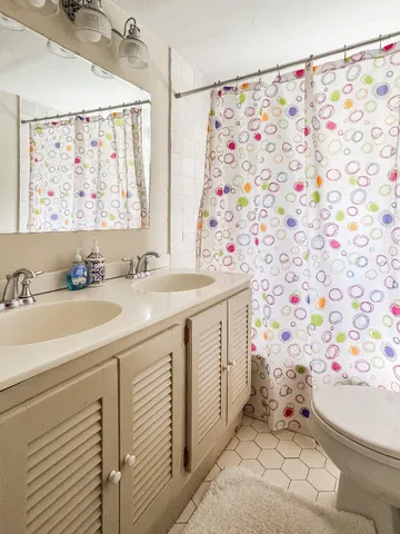 a bathroom with a sink mirror vanity and toilet