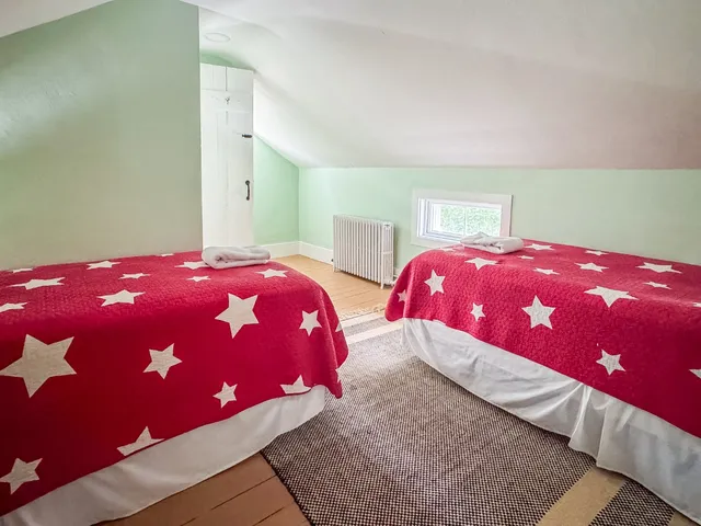 a bedroom with a bed and two lamp