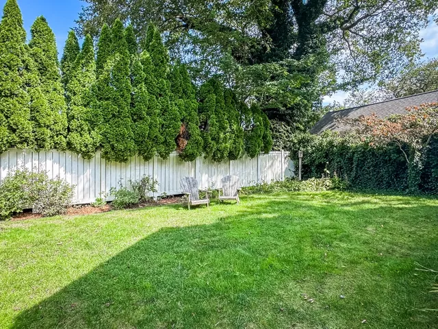 a front view of a house with a garden and plants