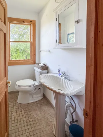 a bedroom with bed and window