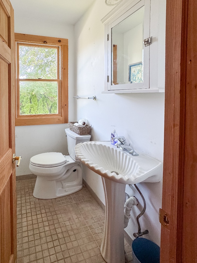 69 School Street Edgartown, MA 02539 - Photo 22 of 23 a bathroom with a sink a toilet and a mirror