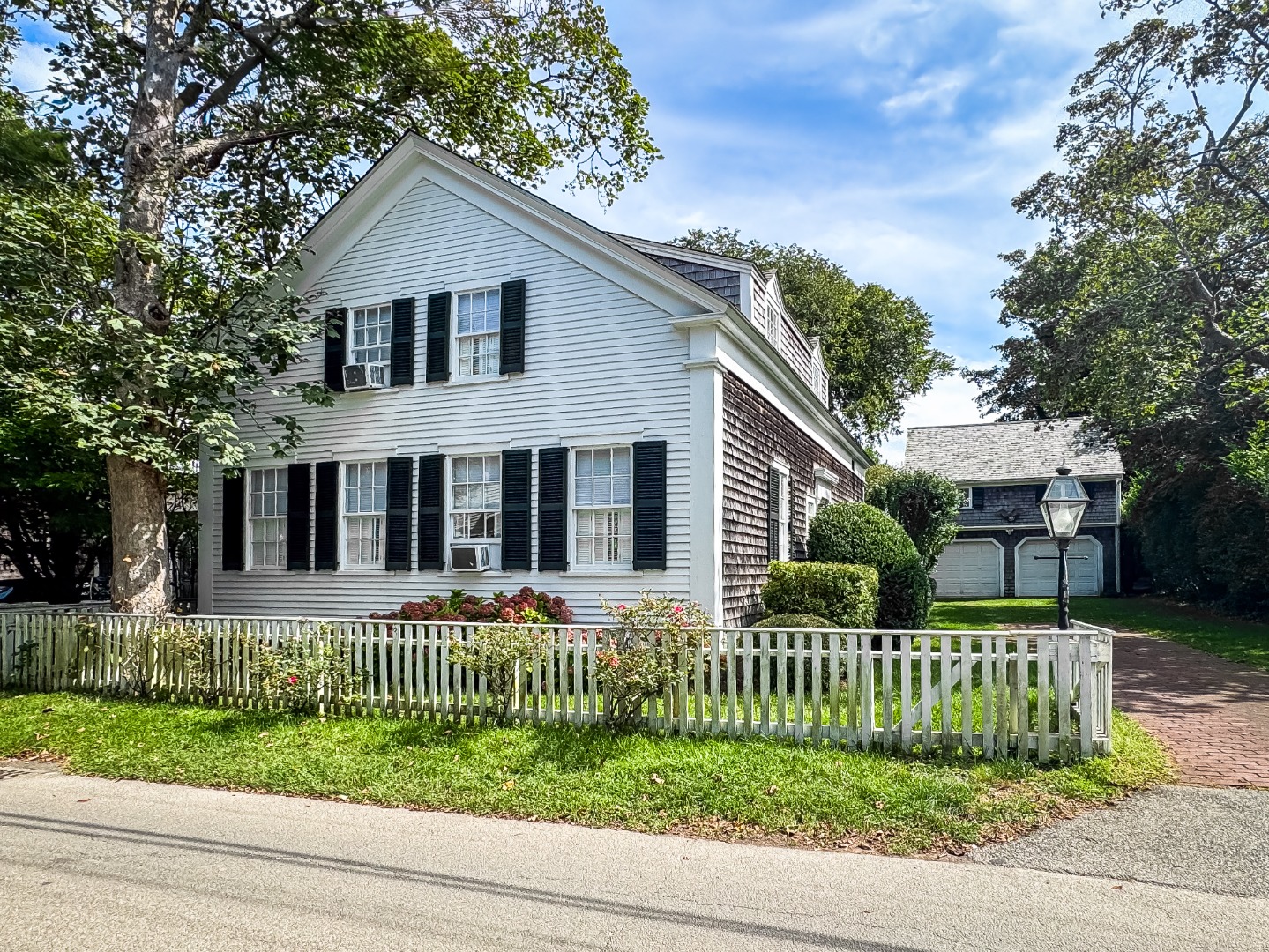 69 School Street Edgartown, MA 02539 - Photo 3 of 23 a front view of a house with a small yard