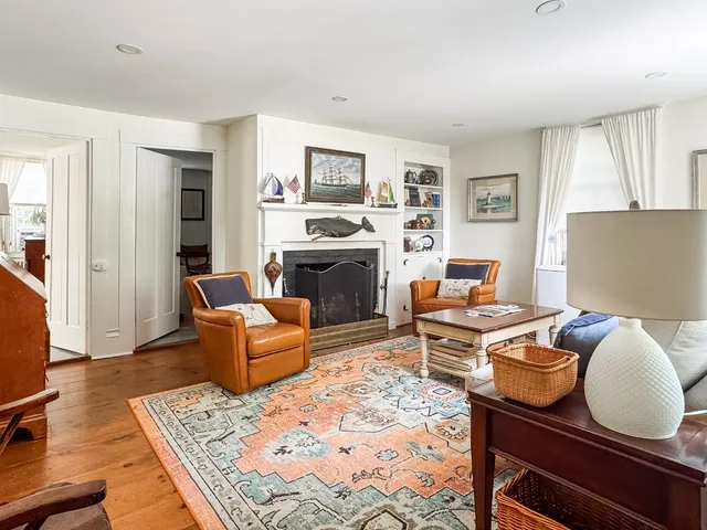 a living room with furniture fireplace and a window