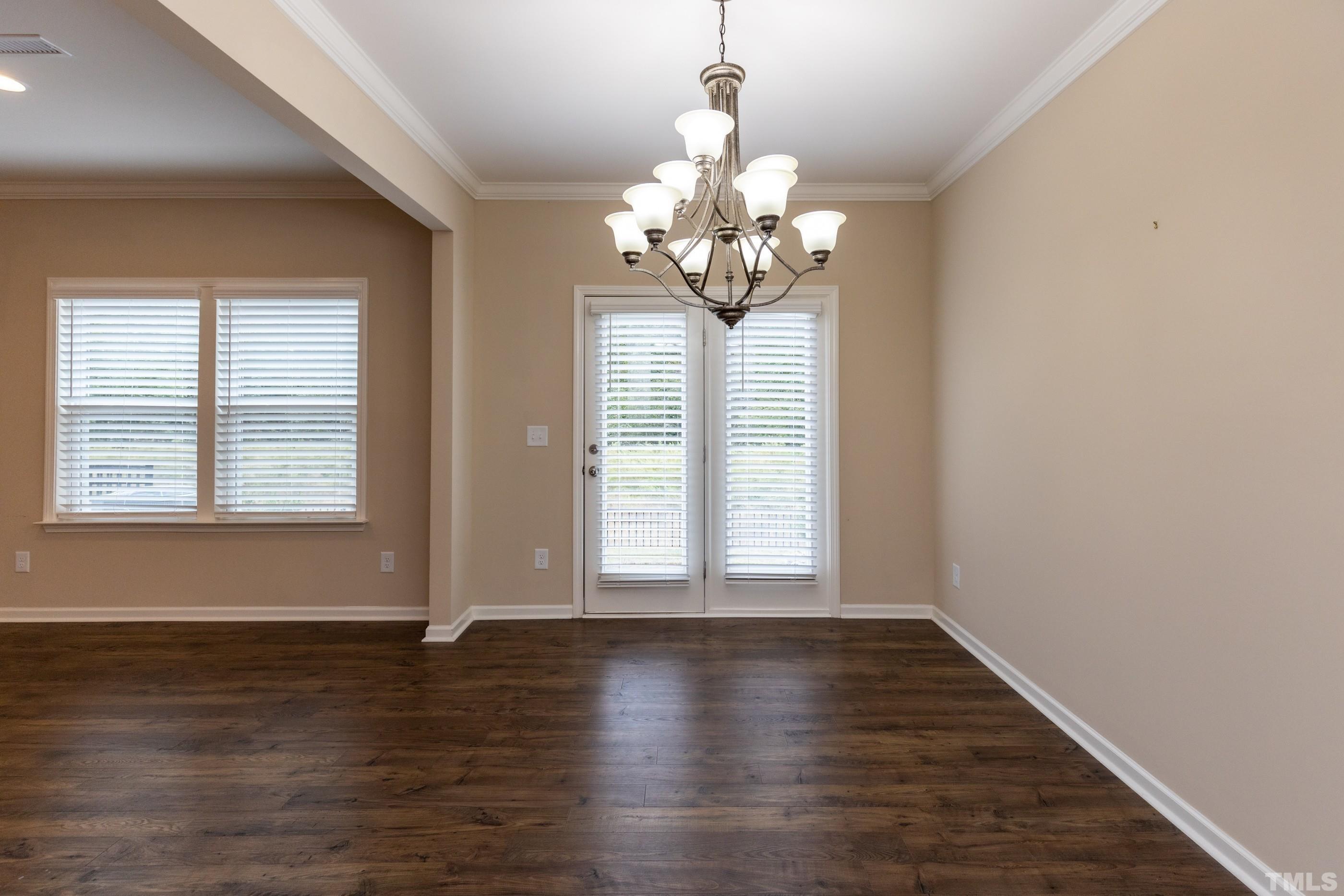 566 Chessie Station Apex, NC 27502 - Photo 14 of 29 an empty room with wooden floor and windows